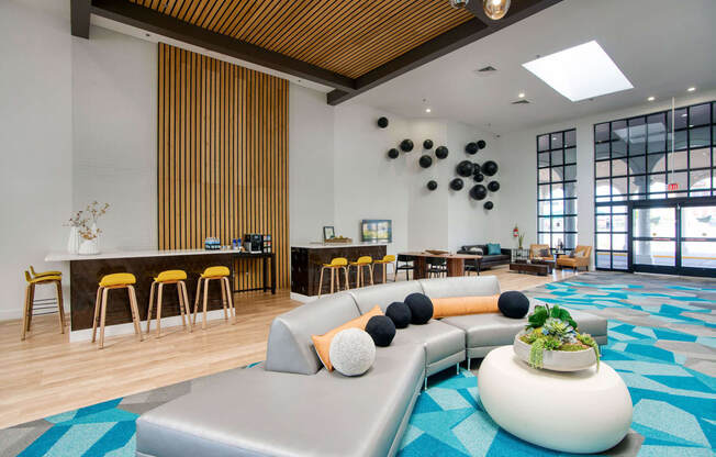 the lobby of a hotel with a large couch and tables at Presidio Palms Apartments, Arizona, 85701