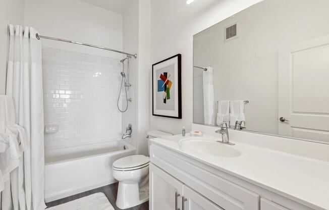 a bathroom with a bathtub toilet and sink at Metro 303, Hempstead, NY 11550
