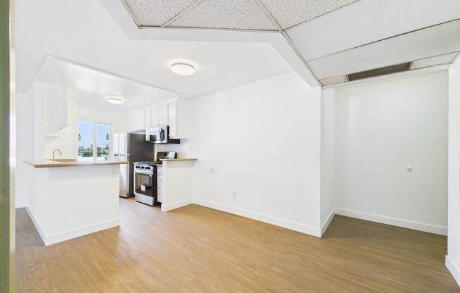 A kitchen area with a stove, oven, and sink.