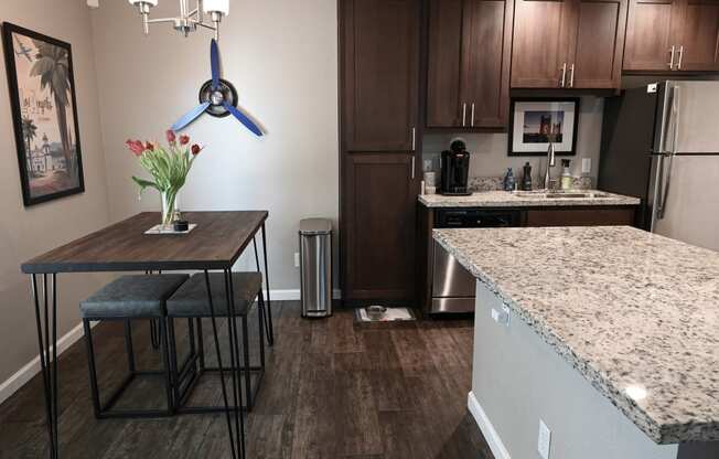 a kitchen with a table and two stools