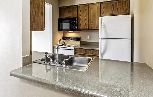 a kitchen with a sink and a refrigerator