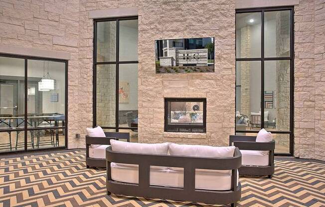 a room with a couch and a wall with a geometric design at Hunters Creek Apartments, Denton Texas