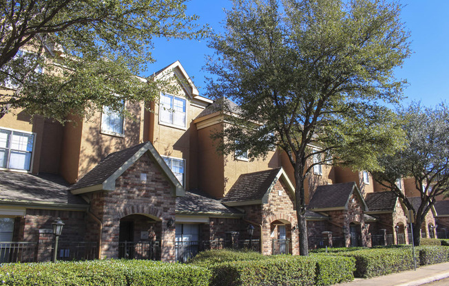 This is a photo of some Townhome exteriors at The Brownstones Townhome Apartments in Dallas, TX.