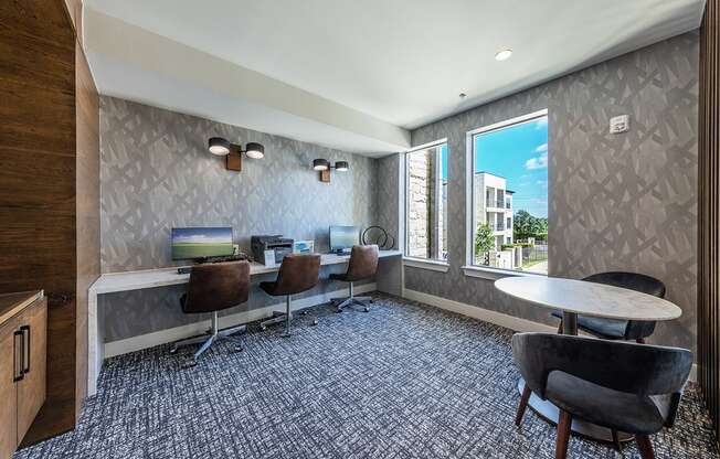 A conference room with a long table and chairs.
