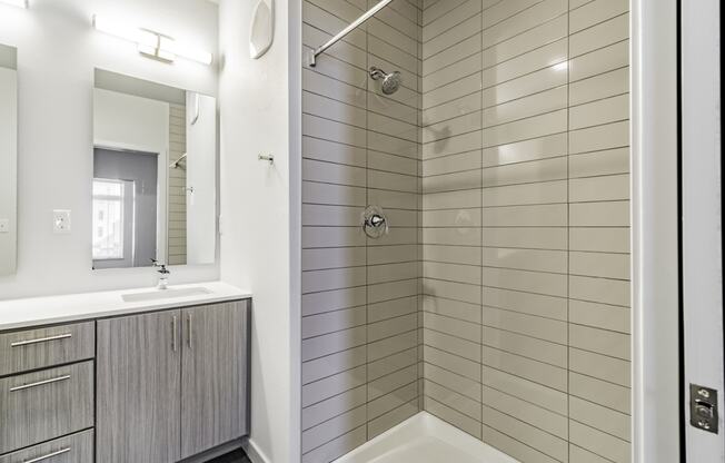 Bathrooms featuring quartz countertops extra storage and space at Pinnacle Heights Apartments at Rogers, Arkansas.