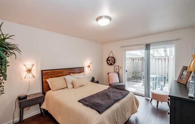 a bedroom with a bed and a sliding glass door