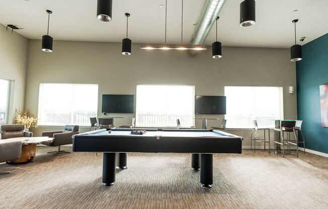 A room with a pool table and a television. at The Platform, Washington