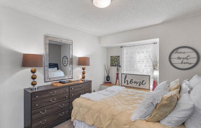 a bedroom with a bed and dresser