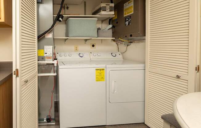 A small white fridge in a small room.