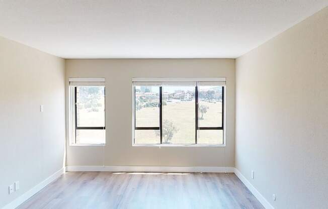 an empty room with three windows
