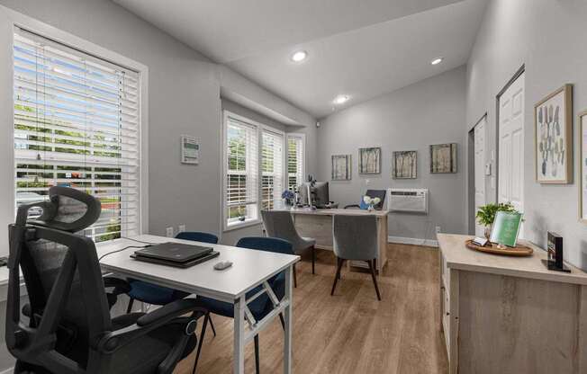 a home office with a desk and a chair and a window