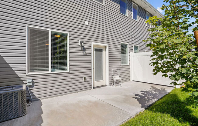 a side view of a house with a patio and a door