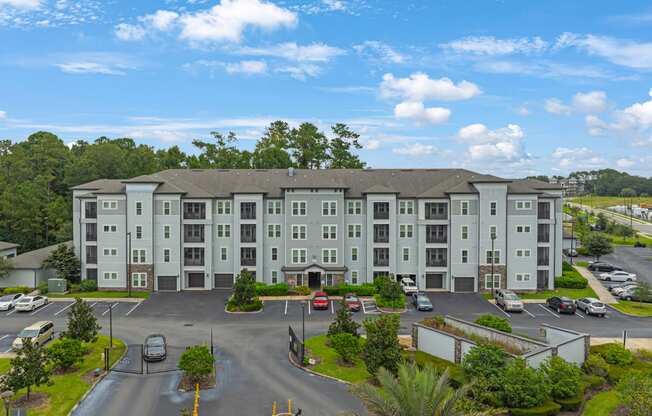 an aerial view of a large apartment building with a parking lot