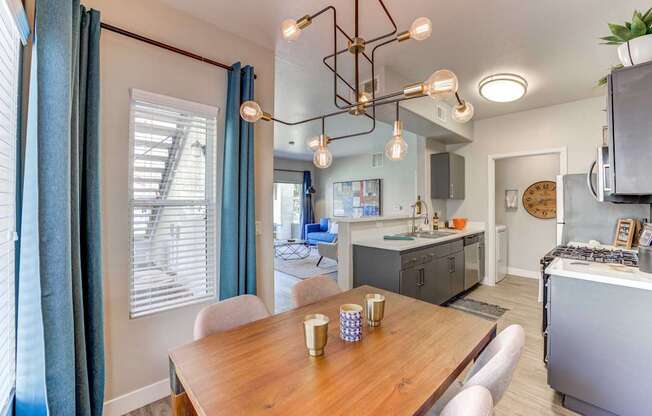 A dining room with a wooden table and chairs.