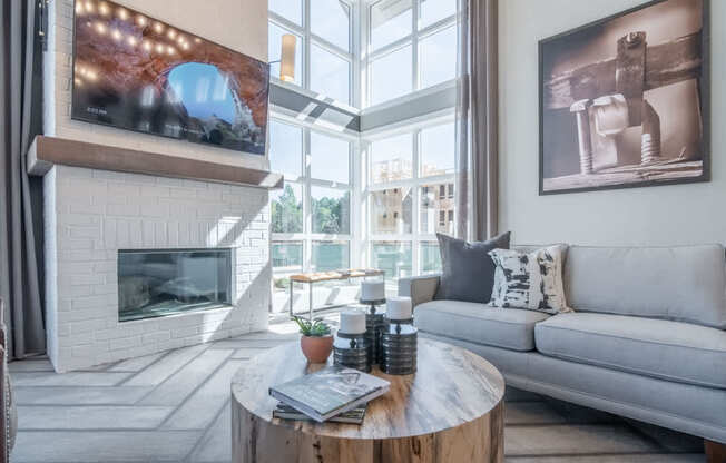 a living room with a fireplace and a couch and a coffee table
