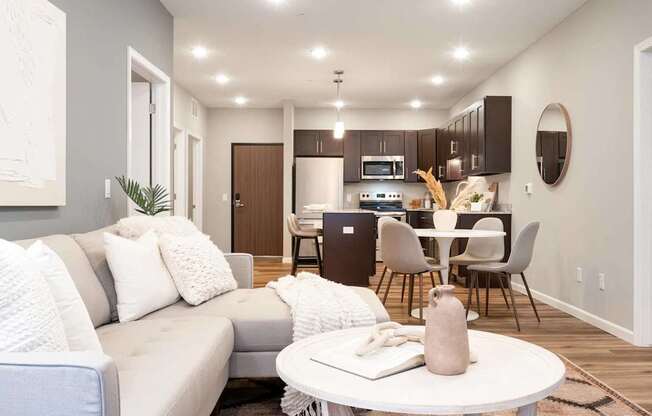 a living room with a couch and a table. Circle Pines, MN Lexington Lofts