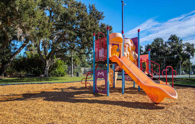A playground with a slide and a climbing frame.