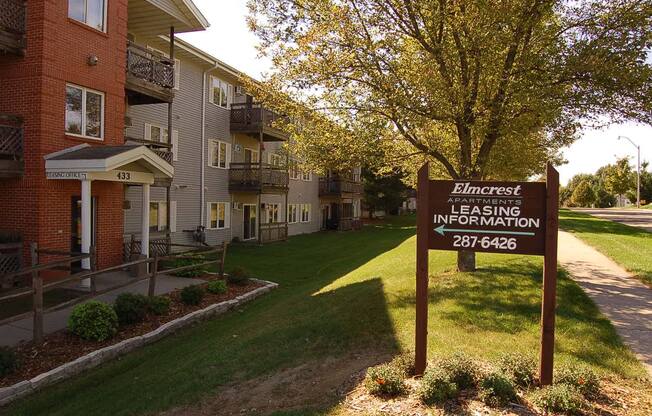 a sign in front of an apartment building