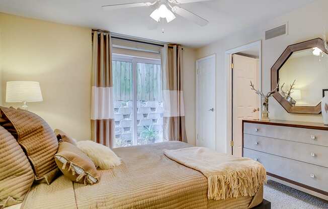 apartment bedroom with walk in closet and large window at the villages at general grant