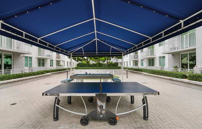 a ping pong table in the middle of an apartment complex