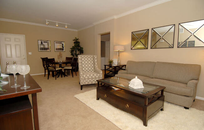 Livingroom with furniture, a rug and decor on the walls.