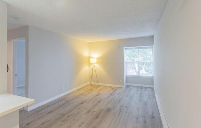 an empty living room with wood floors and a window  at Skyline Heights LLC, Daly City