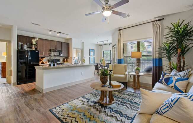 a living room and kitchen area with a ceiling fan at Alvista Round Rock, Round Rock, TX, 78664