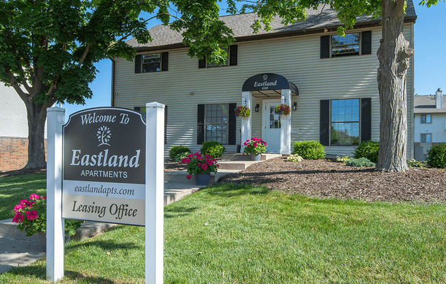 a leasing office sign in front of a house