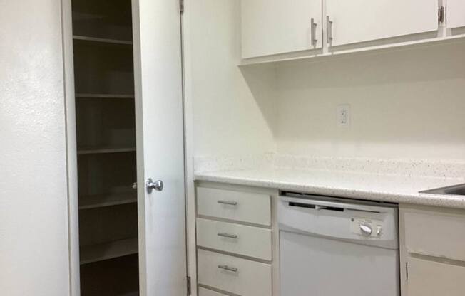A white laundry room with a washer and dryer.