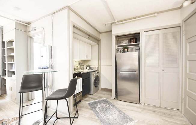 entrance into kitchen with stainless steel appliances and wood-style flooring