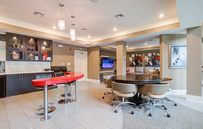 a clubhouse with a red bar and a tv in the back