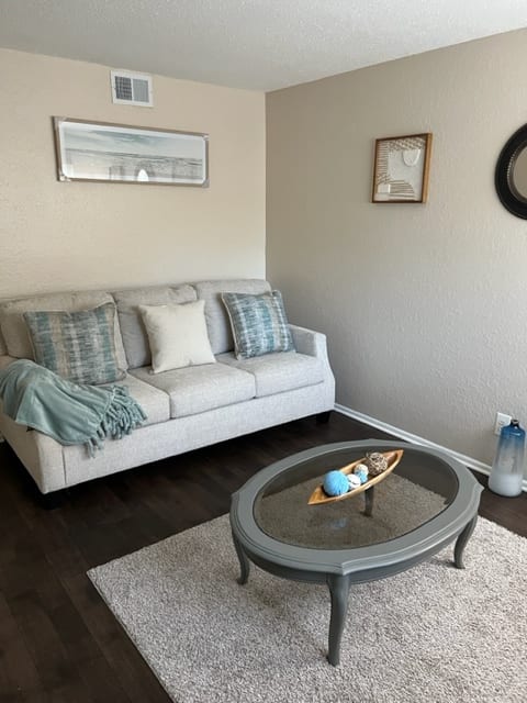 a living room with a couch and a mirror