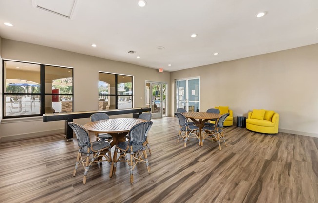 a dining room with a table and chairs and a large window