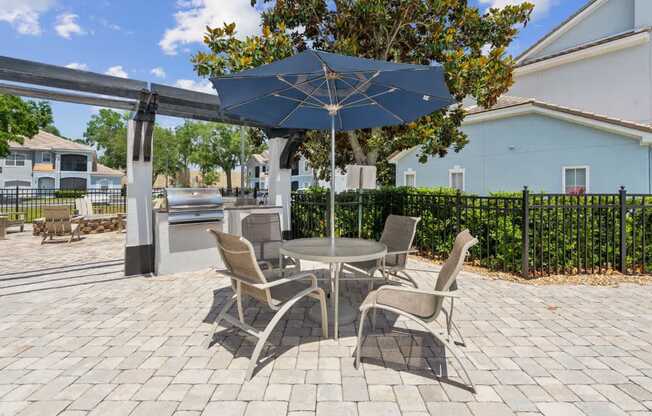 A BBQ and Grill area featuring a patio table and chairs