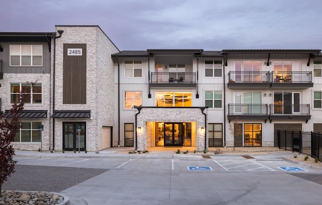 an image of an apartment building with an empty parking lot