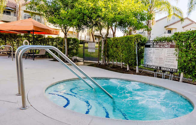 A pool with a slide and a sign in the background.