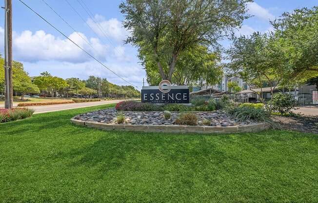Monument Sign and Front Entrance at Essence Apartments in Dallas, TX.