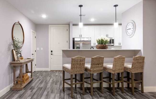 A kitchen with a dining table and chairs.