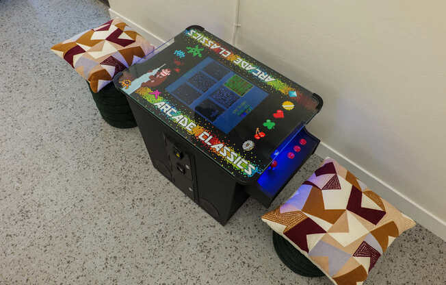 A small arcade machine sits on a carpeted floor.