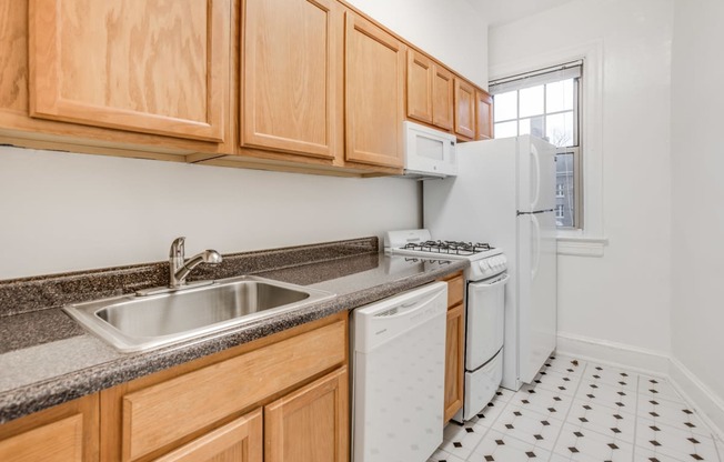 a kitchen with white appliances and wooden cabinets