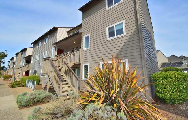 a row of town homes with stairs and balconies