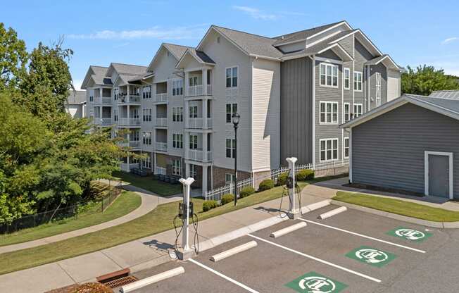 an empty parking lot in front of an apartment building