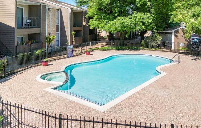 a beautiful pool and sundeck beside residential buildings at Kirkwood Landing