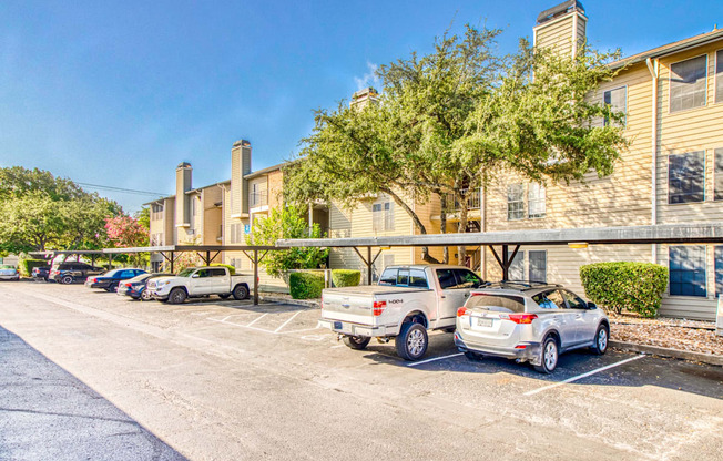 Carport spaces and apartment exteriors at Hillside Creek Apartments in Austin, TX