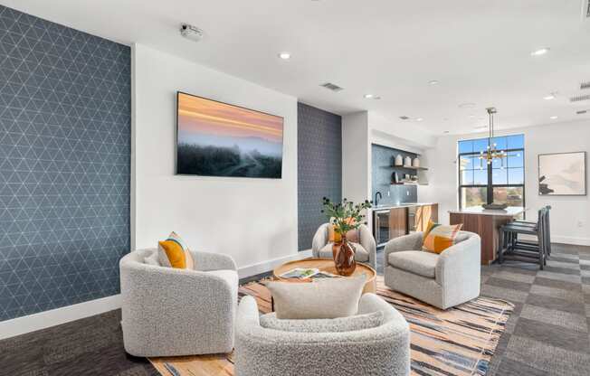 a living room with chairs and a table at The Colony, Charlotte, NC