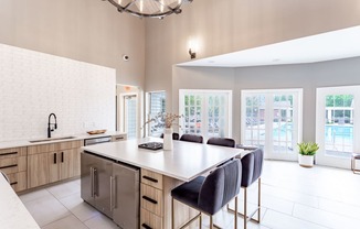 a kitchen with a large island and a chandelier