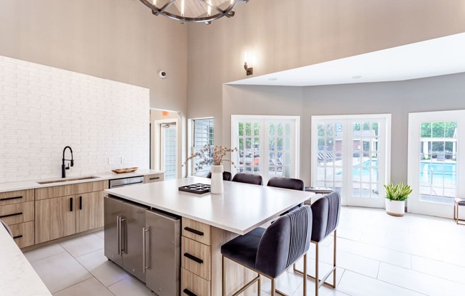 a kitchen with a large island and a chandelier