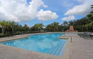 Crystal clear pool with tanning deck at The Columns at Bear Creek, New Port Richey, Florida