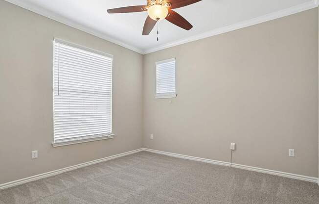 Kenzington bedroom with carpet and a ceiling fan at Encore at Buckingham Apartments in Richardson, TX