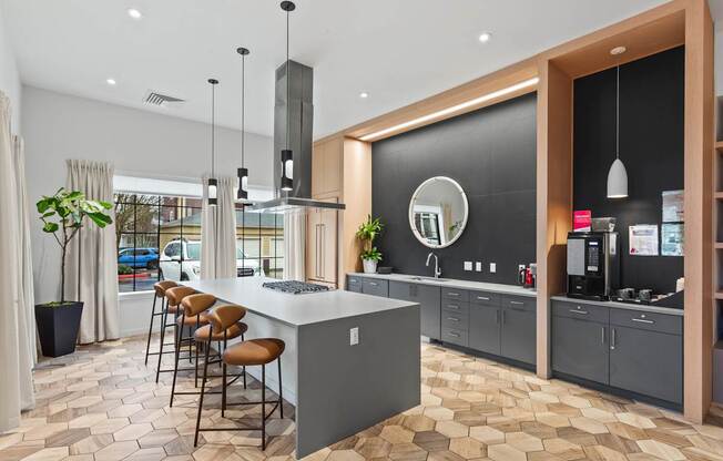 A modern kitchen with a large island and bar stools.